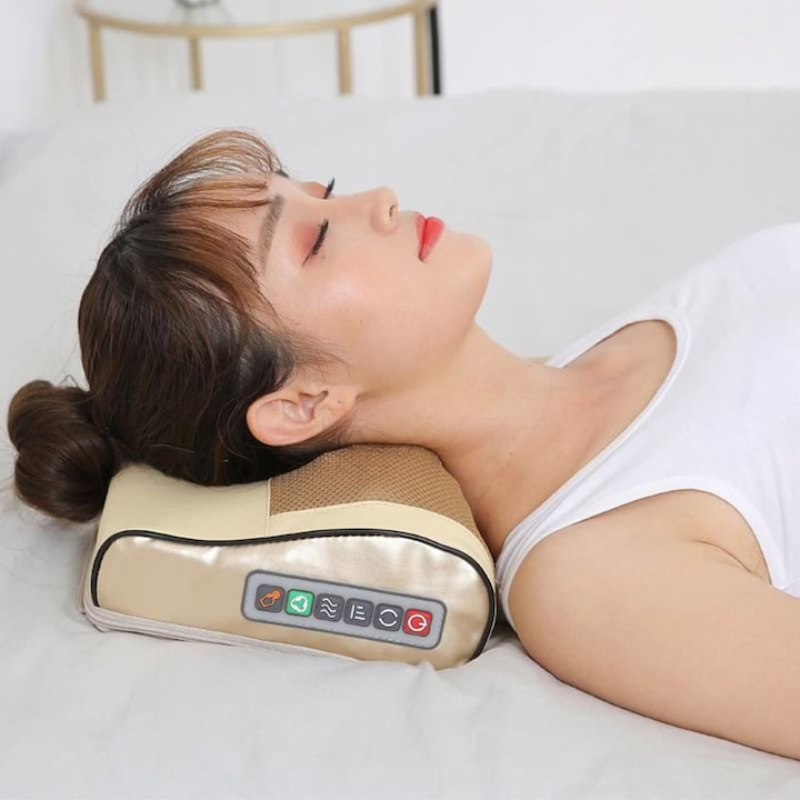 Woman using a neck massager on a bed