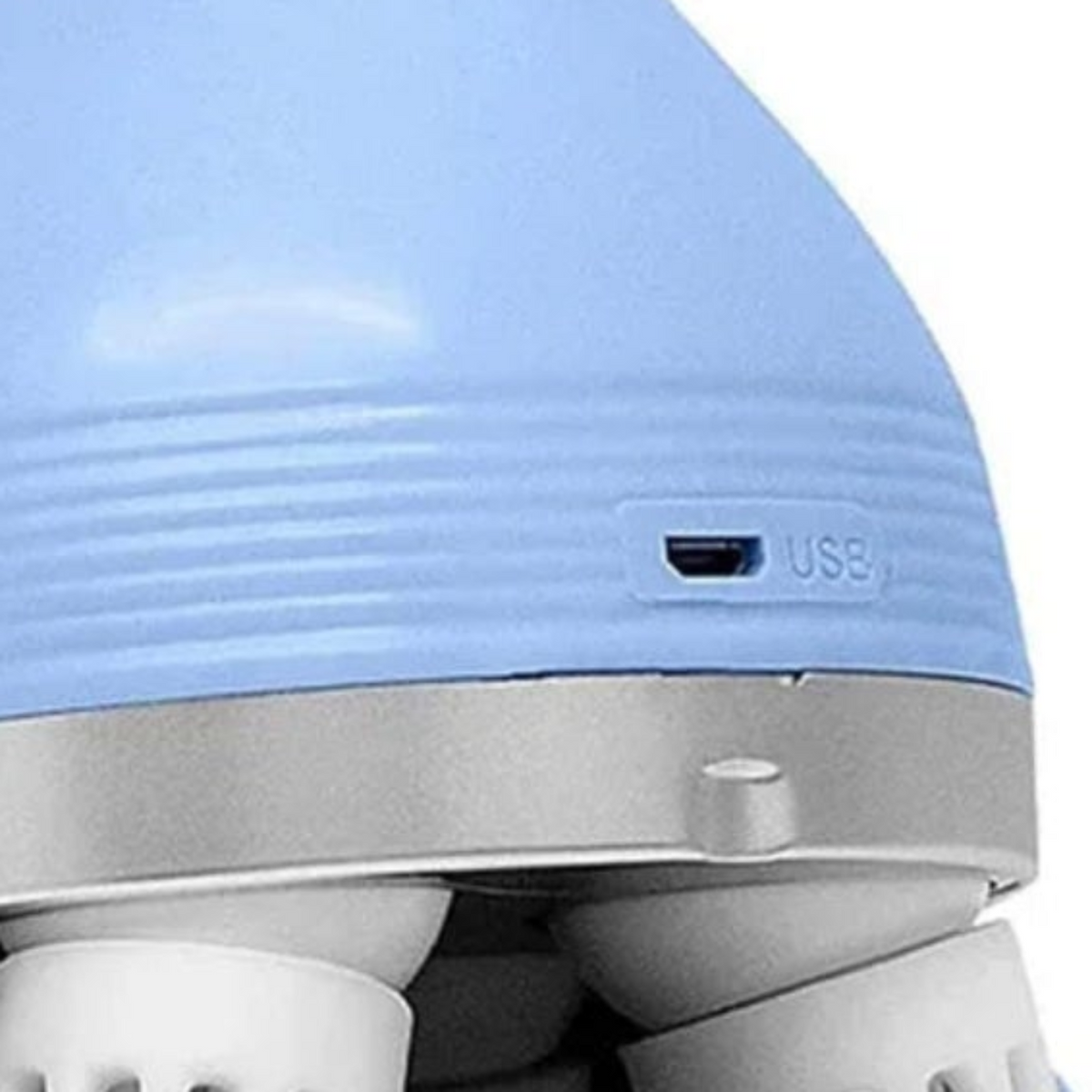 Close-up of the USB charging port and textured blue housing of the scalp massager.
