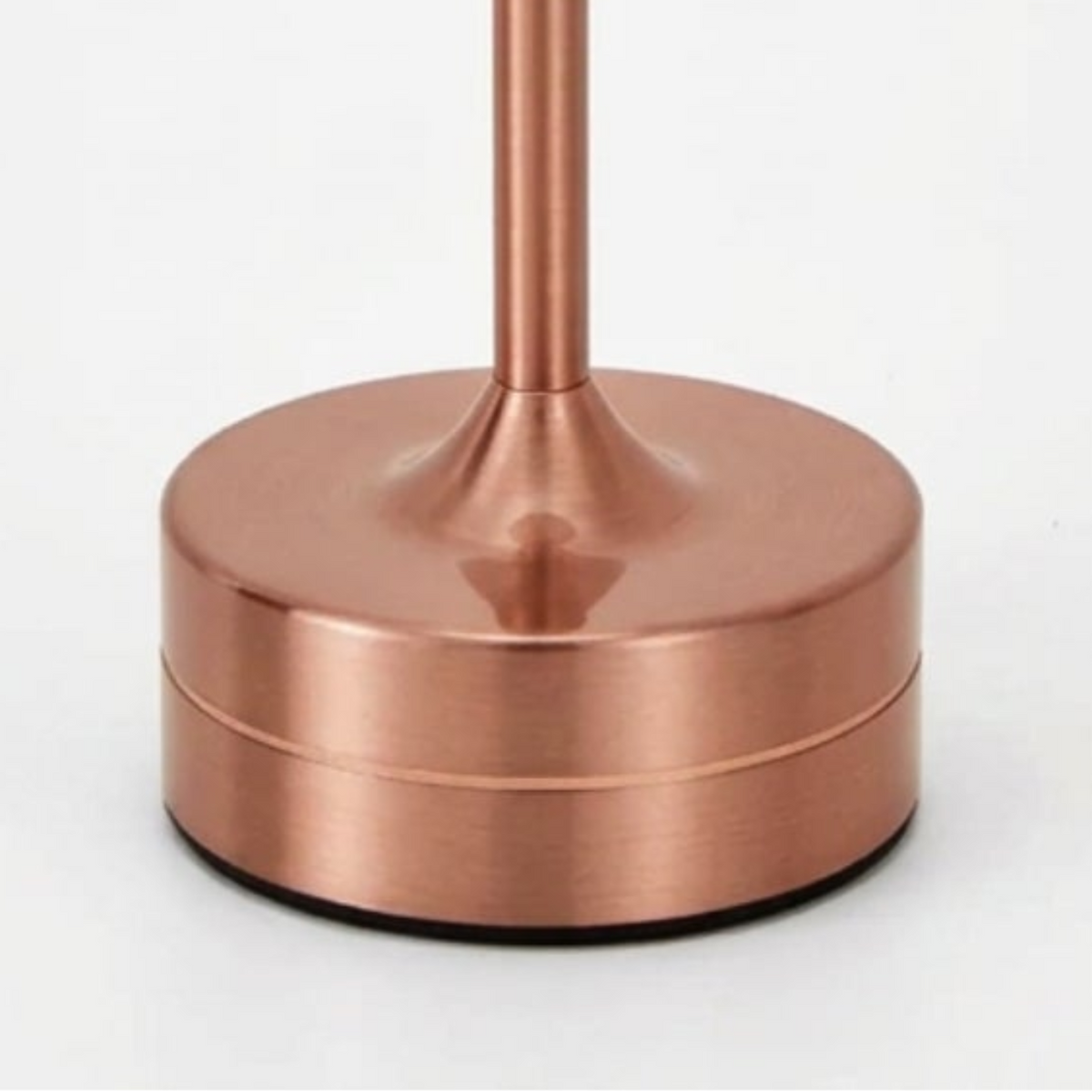 Close-up of the rose-gold cylindrical metal base and slim stem