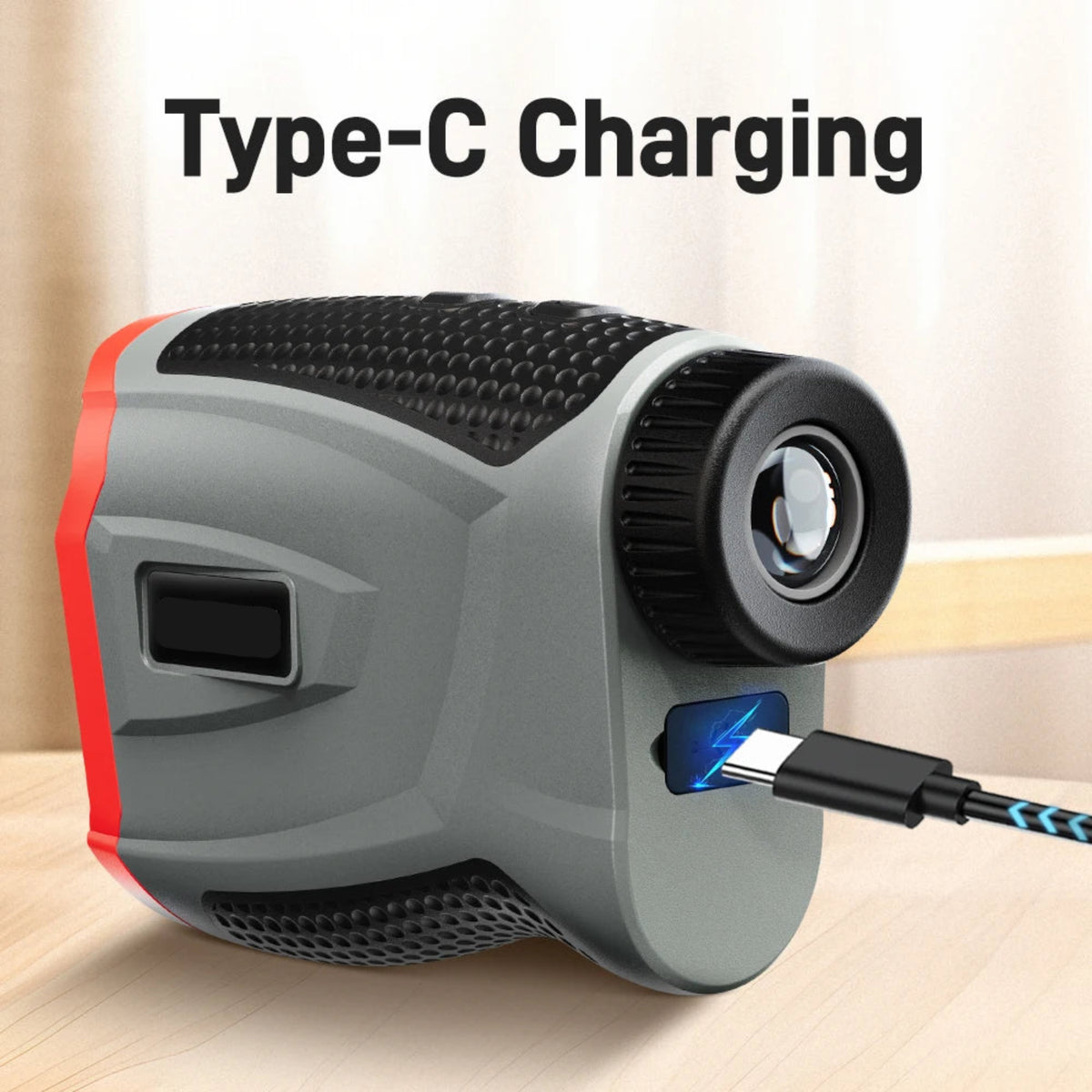 USB-C charging connection on the grey and red rechargeable golf rangefinder; charging cable shown for illustration