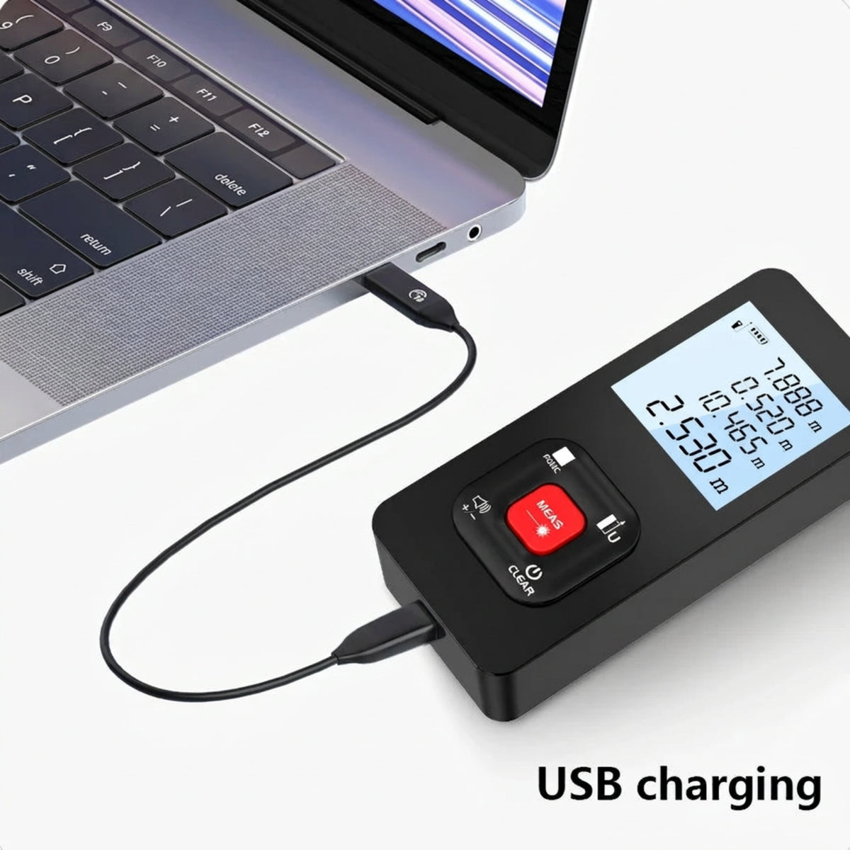 Laser distance meter connected to a laptop by its USB charging cable