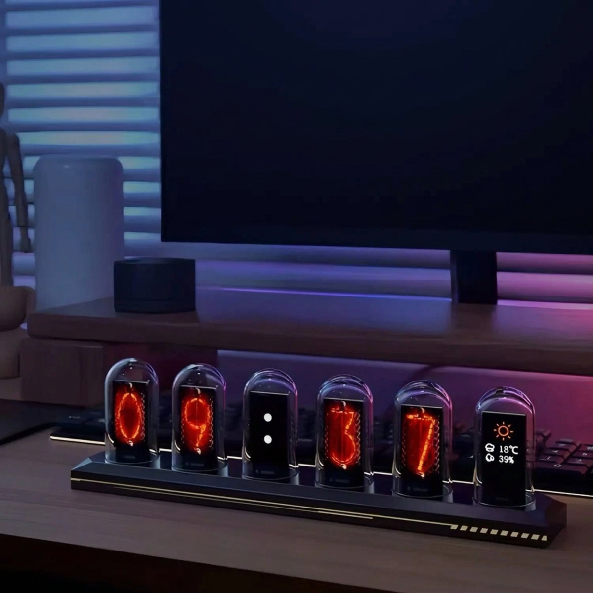 Six-screen IPS desk clock on a desk showing a digital time face and an example of weather information from its connected service