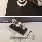 Stirling engine kit showing the burner, demonstration bulb with lead, adjustment keys and spare seals