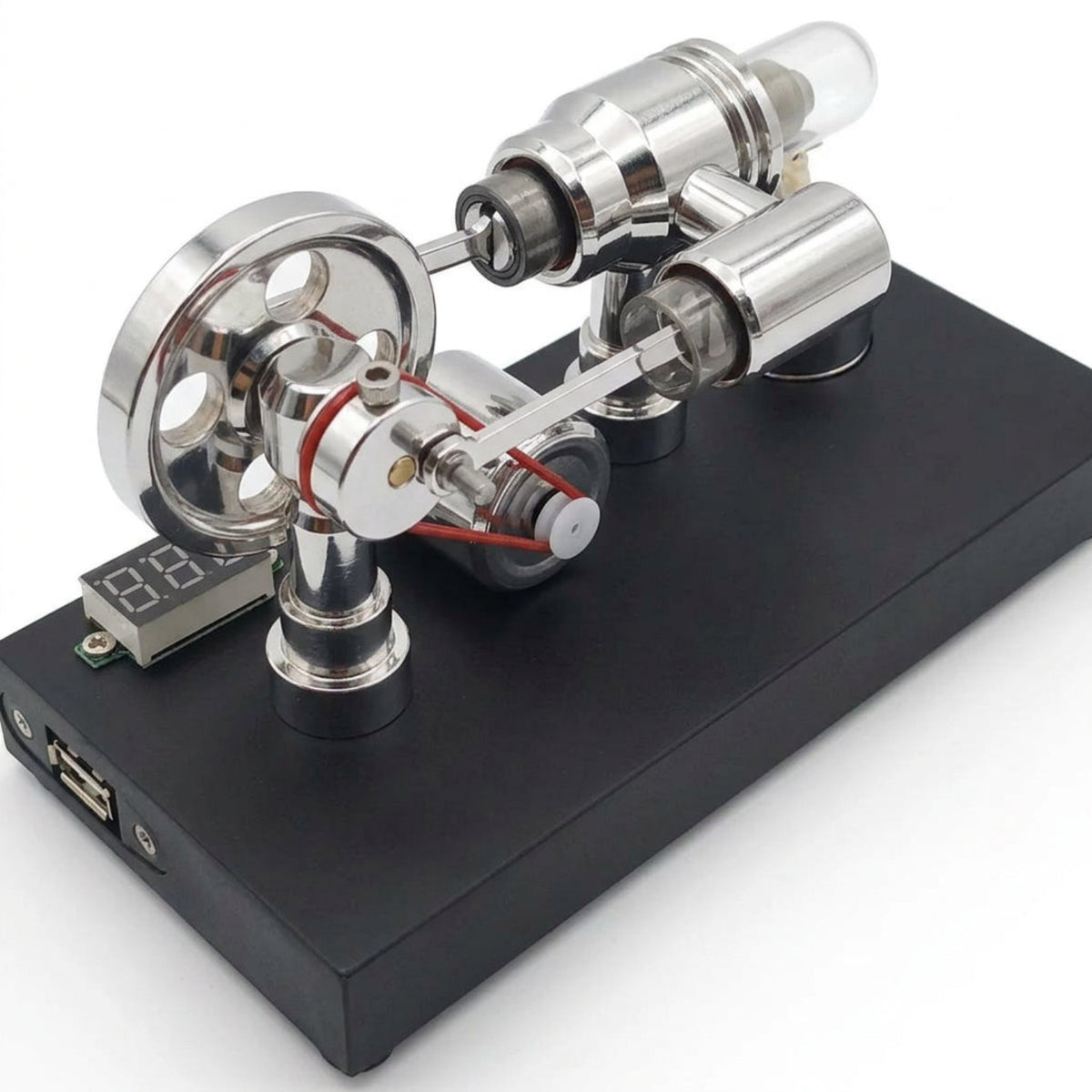 Polished Stirling engine generator on a white background with digital voltmeter and black display base