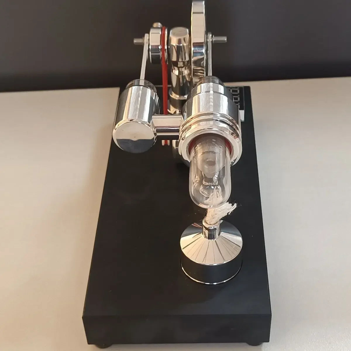End view of the Stirling engine quartz heating cylinder and burner on the display base